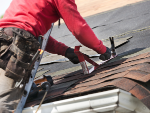 High Ridge storm damage roofers from Gateway Brothers securing a damaged roof.