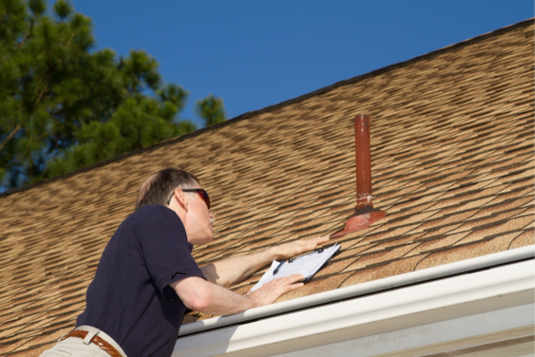 Gateway Brothers Construction team inspecting roof damage in High Ridge.