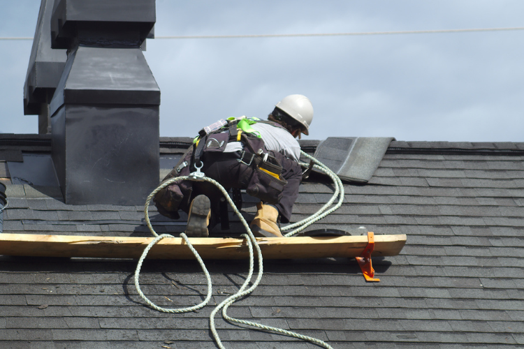Professional roofer repairing a roof